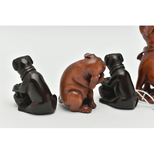 95 - FOUR 20TH CENTURY CARVED TREEN NETSUKE AND TWO OKIMONO, all in the form of dogs, five with inset eye... 