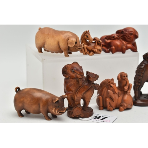 97 - SIX 20TH CENTURY CARVED TREEN NETSUKE AND AN OKIMONO, carved as pigs, horses, goat, etc, all with in... 