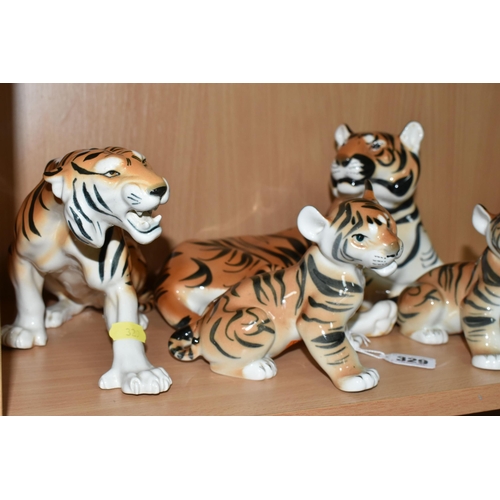 329 - A GROUP OF LOMONOSOV TIGERS, comprising a large recumbent tiger, height 17cm x length 30cm (remnants... 