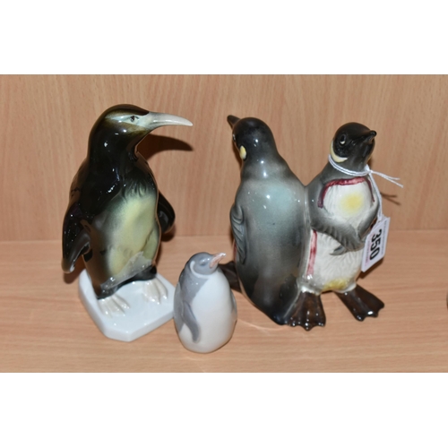 350 - THREE CERAMIC PENGUIN FIGURES, comprising a Beswick Courting Penguins figure group, model no 1015, a... 