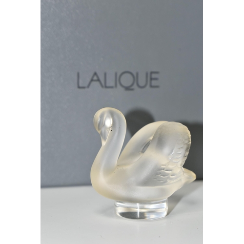 351 - A BOXED LALIQUE SWAN PAPERWEIGHT, with frosted swan on a clear circular base, height 4.5cm, with etc... 