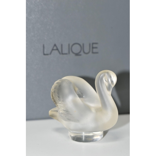 351 - A BOXED LALIQUE SWAN PAPERWEIGHT, with frosted swan on a clear circular base, height 4.5cm, with etc... 