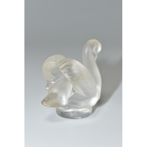 351 - A BOXED LALIQUE SWAN PAPERWEIGHT, with frosted swan on a clear circular base, height 4.5cm, with etc... 