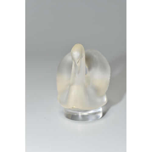 351 - A BOXED LALIQUE SWAN PAPERWEIGHT, with frosted swan on a clear circular base, height 4.5cm, with etc... 