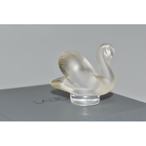 351 - A BOXED LALIQUE SWAN PAPERWEIGHT, with frosted swan on a clear circular base, height 4.5cm, with etc... 