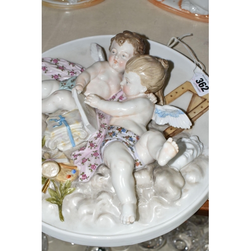 362 - A PORCELAIN PLAQUE DEPICTING A PAIR OF CHERUBS, AND TWO GERMAN SPANIEL FIGURES, the circular plaque ... 