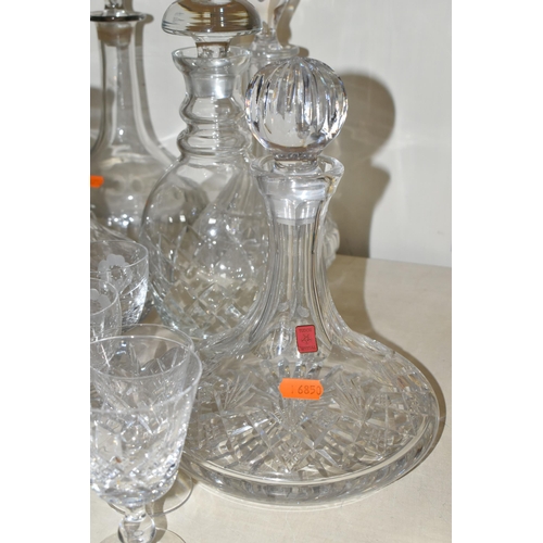 365 - A QUANTITY OF CUT CRYSTAL, over fifty pieces to include twelve decanters, a large geometric vase, a ... 