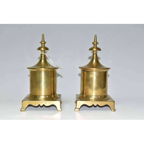 399 - TWO BRASS TOBACCO JARS, with covers, the jars of cylindrical form supported on four feet, height 23c... 