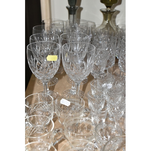 464 - A QUANTITY OF CUT CRYSTAL AND GLASSWARE, comprising mid- century smoked glass decanters, three other... 