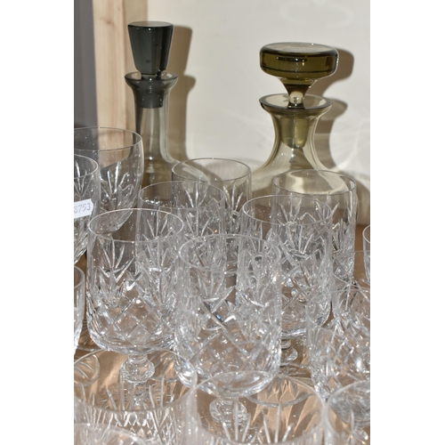 464 - A QUANTITY OF CUT CRYSTAL AND GLASSWARE, comprising mid- century smoked glass decanters, three other... 