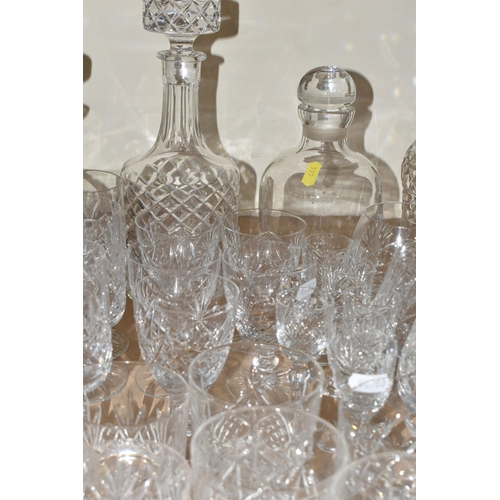 464 - A QUANTITY OF CUT CRYSTAL AND GLASSWARE, comprising mid- century smoked glass decanters, three other... 