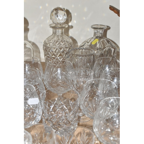 464 - A QUANTITY OF CUT CRYSTAL AND GLASSWARE, comprising mid- century smoked glass decanters, three other... 