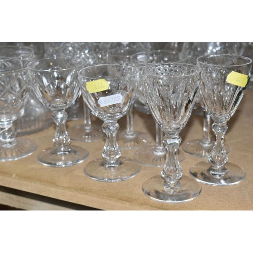 464 - A QUANTITY OF CUT CRYSTAL AND GLASSWARE, comprising mid- century smoked glass decanters, three other... 