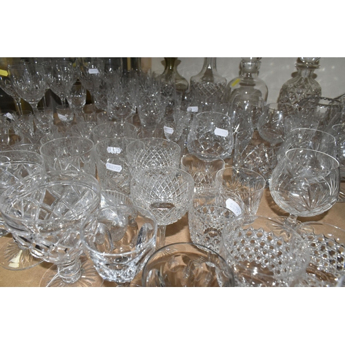 464 - A QUANTITY OF CUT CRYSTAL AND GLASSWARE, comprising mid- century smoked glass decanters, three other... 