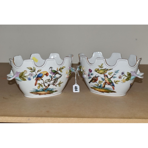 484 - A PAIR OF LATE 19TH / EARLY 20TH CENTURY CONTINENTAL PORCELAIN TWIN HANDLED CACHE-POT PLANTERS, the ... 