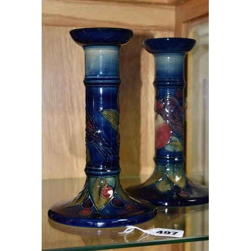 497 - A PAIR OF MODERN MOORCROFT POTTERY CANDLESTICKS DECORATED WITH FINCHES AND FRUIT, painted and impres... 