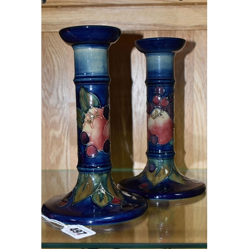 497 - A PAIR OF MODERN MOORCROFT POTTERY CANDLESTICKS DECORATED WITH FINCHES AND FRUIT, painted and impres... 