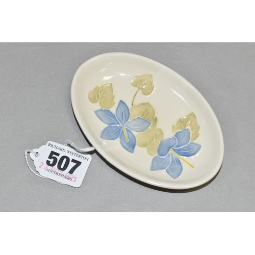 507 - A MOORCROFT POTTERY OVAL PIN DISH DECORATED WITH A CAMPANULA PATTERN ON A CREAM GROUND, impressed ma... 