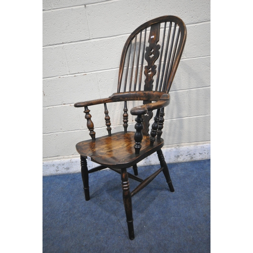 1203 - A 19TH CENTURY STAINED ELM WINDSOR ARMCHAIR, with spindled back rest, turned supports, legs and stre... 