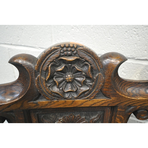 1206 - A PAIR OF EARLY 20TH CENTURY OAK THRONE CHAIRS, carved with floral crest, flanked by two finials, th... 