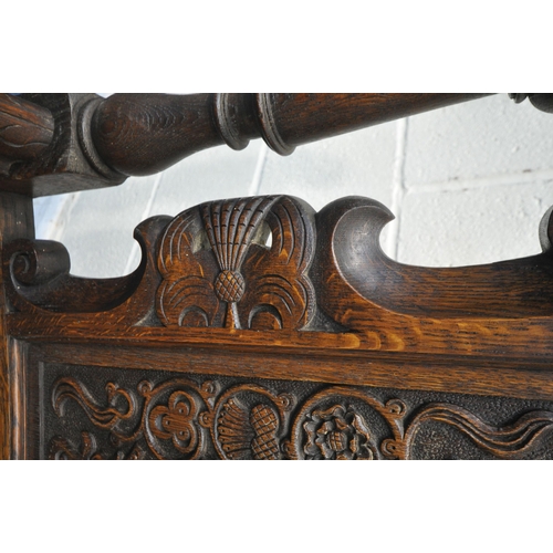 1206 - A PAIR OF EARLY 20TH CENTURY OAK THRONE CHAIRS, carved with floral crest, flanked by two finials, th... 