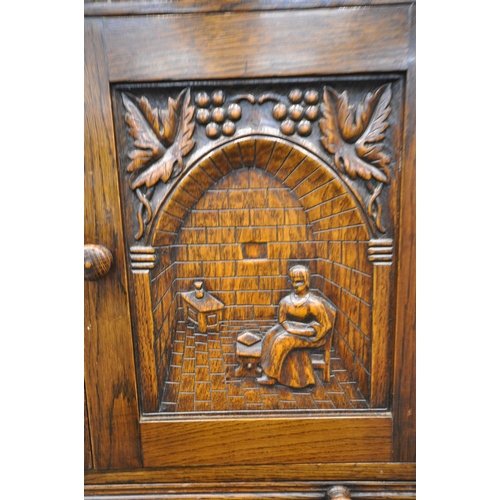 1211 - A 20TH CENTURY SOLID OAK DRINKS CABINET, the two double doors , carved with a seated person, an arch... 