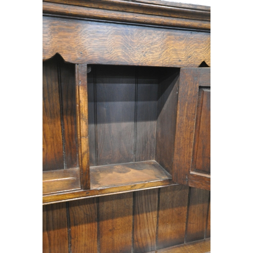 1212 - IN THE MANNER OF TITCHMARSH AND GOODWIN, A SOLID OAK DRESSER, the top fitted with an arrangement of ... 