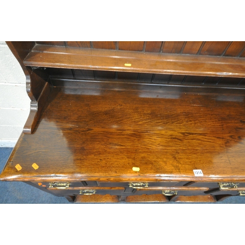 1214 - IN THE MANNER OF TITCHMARSH AND GOODWIN, A SOLID OAK DRESSER, the top being a three tier plate rack,... 