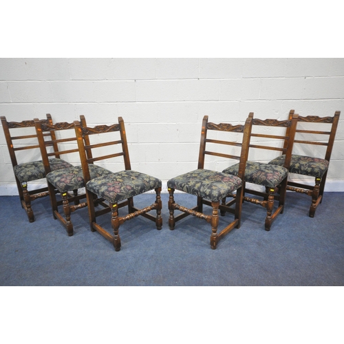 1222 - A SET OF SIX REPRODUCTION OAK LADDER BACK DINING CHAIRS, the top rail with scrolled carving, dark bl... 