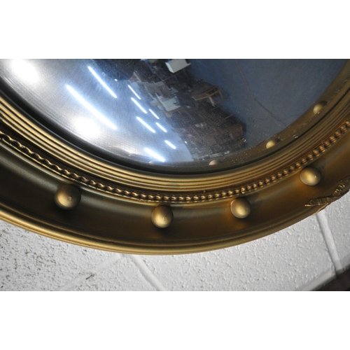 1229 - A REGENCY STYLE GILT FRAMED CIRCULAR CONVEX WALL MIRROR, diameter 53cm, a gilt framed bevelled edge ... 