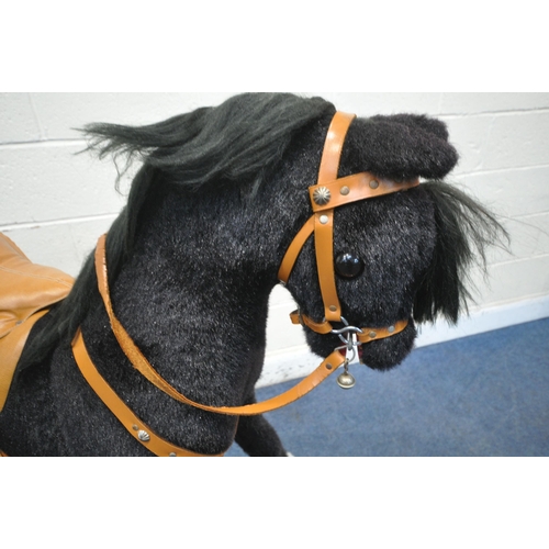 1238 - A PEGASUS OF CREWE CHILDS BLACK AND WHITE ROCKING HORSE, with tanned leather saddle and accessories,... 