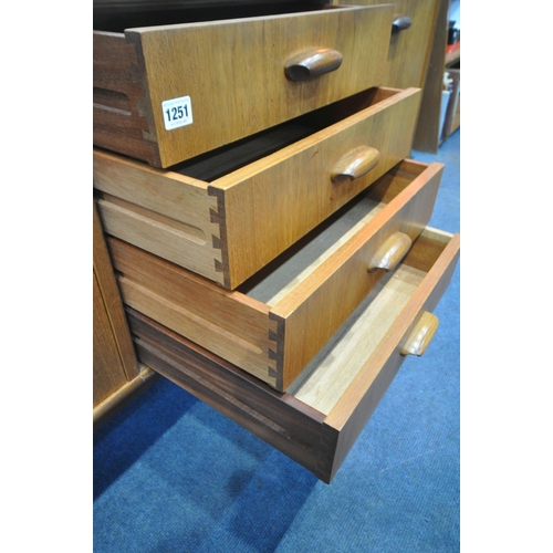 1251 - A MID CENTURY TEAK G PLAN SIDEBOARD, fitted with double cupboard doors, four recessed drawers, top d... 