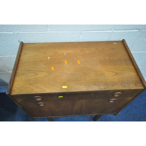 1252 - A MID CENTURY TEAK EXTENDING DINING TABLE, with a single fold out leaf, on cylindrical tapered legs,... 