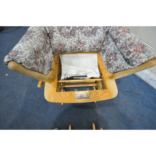 1255 - A DUTAILIER BEECH ROCKING ARMCHAIR AND STOOL, with floral upholstery, the chair with a rocking lock ... 
