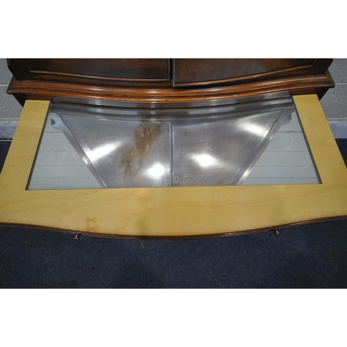 1258 - A REPRODUX FLAME MAHOGANY SERPENTINE COCKTAIL CABINET, fitted with four cupboard doors, a brushing s... 