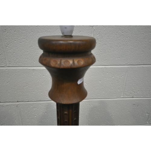 1281 - A 20TH CENTURY OAK STANDARD LAMP, with turned and carved pillar support, on a domed and stepped base... 