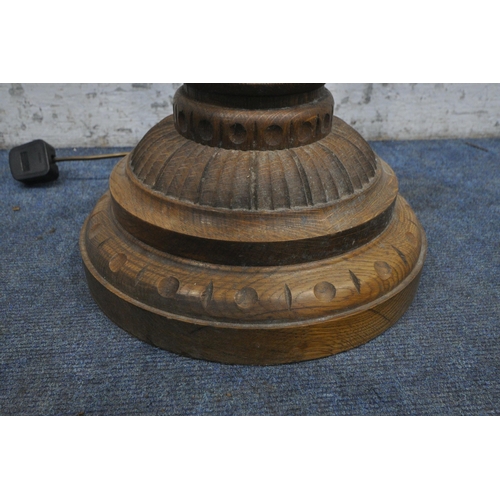 1281 - A 20TH CENTURY OAK STANDARD LAMP, with turned and carved pillar support, on a domed and stepped base... 