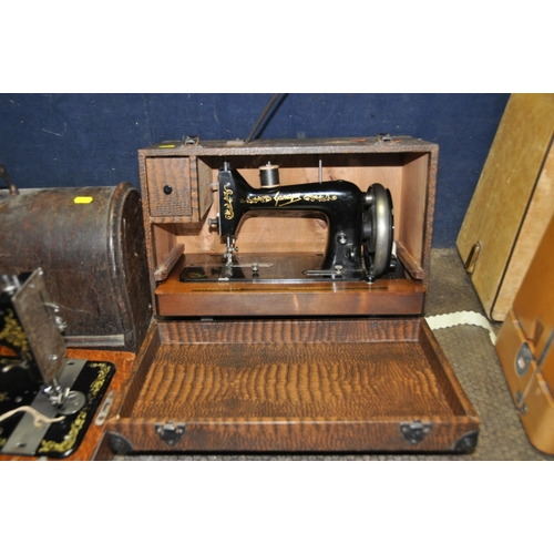 1071 - THREE VINTAGE SEWING MACHINES IN CASES comprising of a manual Singer, an electric Singer (untested)a... 