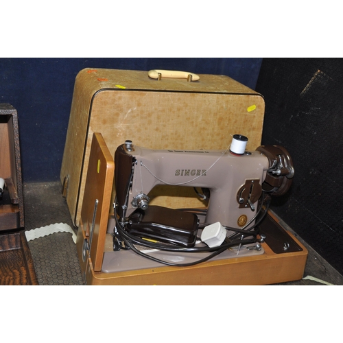 1071 - THREE VINTAGE SEWING MACHINES IN CASES comprising of a manual Singer, an electric Singer (untested)a... 