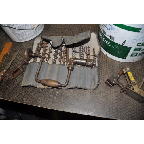 1097 - TWO TUBS CONTAINING TOOLS including a brace and bits, a machine vice, two hold down clamps, bevel sq... 