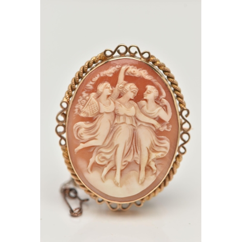 11 - A 9CT GOLD CAMEO BROOCH, of an oval form, carved shell cameo depicting the Three Graces, collet set ... 