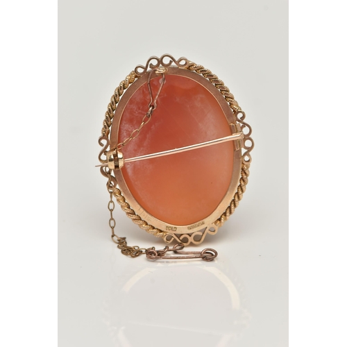 11 - A 9CT GOLD CAMEO BROOCH, of an oval form, carved shell cameo depicting the Three Graces, collet set ... 