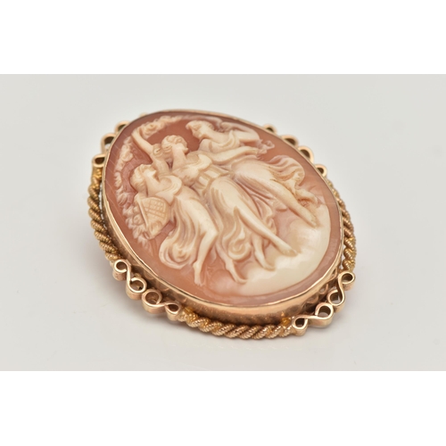 11 - A 9CT GOLD CAMEO BROOCH, of an oval form, carved shell cameo depicting the Three Graces, collet set ... 