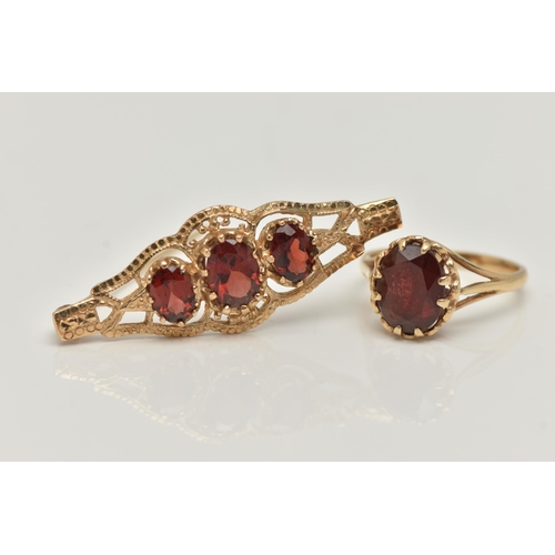 30 - A 9CT GOLD RING AND YELLOW METAL BROOCH, an oval cut garnet, prong set in yellow gold leading on to ... 