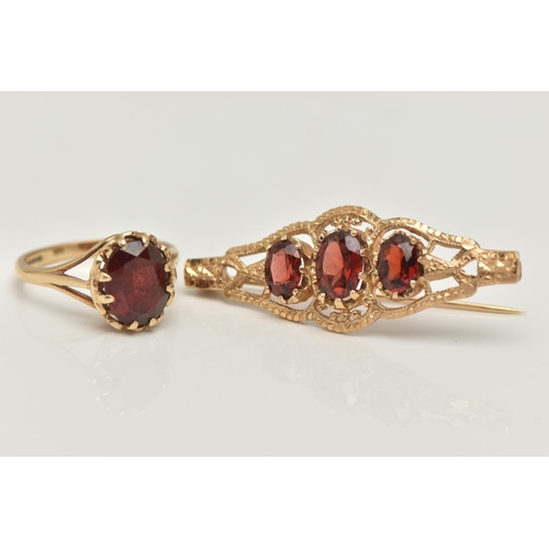 30 - A 9CT GOLD RING AND YELLOW METAL BROOCH, an oval cut garnet, prong set in yellow gold leading on to ... 