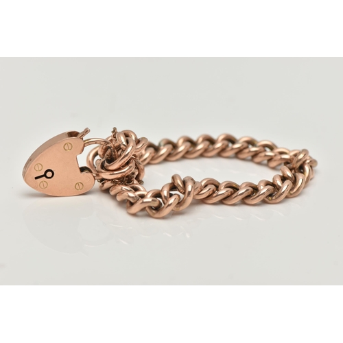 4 - A 9CT GOLD CURB LINK BRACELET, hollow polished curb links, most stamped 9c, fitted with a heart padl... 