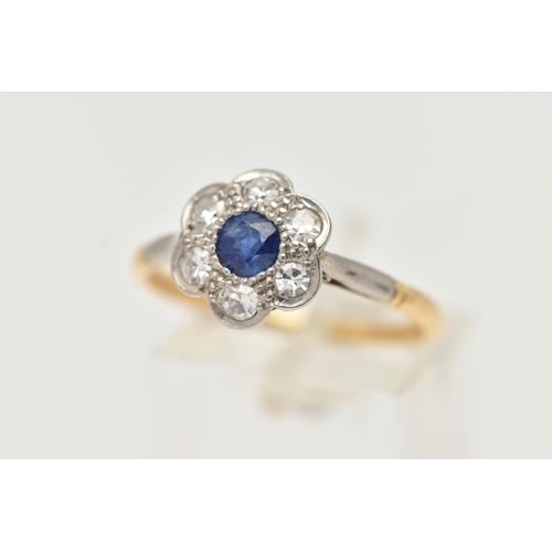 49 - A YELLOW METAL SAPPHIRE AND DIAMOND CLUSTER RING, flower cluster set with a central deep blue, circu... 