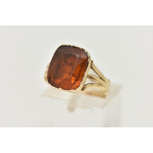 51 - A MID VICTORIAN PASTE RING, the rectangular orange paste in a closed back setting, to the trifurcate... 