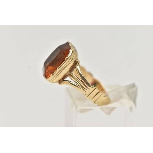 51 - A MID VICTORIAN PASTE RING, the rectangular orange paste in a closed back setting, to the trifurcate... 