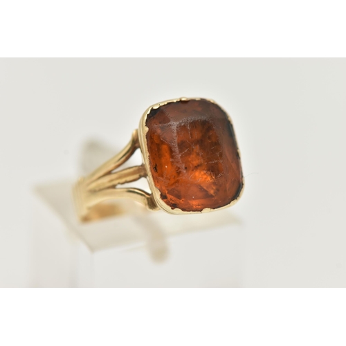 51 - A MID VICTORIAN PASTE RING, the rectangular orange paste in a closed back setting, to the trifurcate... 